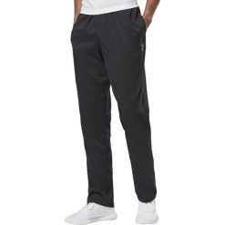 MĘSKIE SPODNIE TRAINING ESSENTIALS WOVEN (M). Spodnie męskie Reebok, m, bez wzorów, ze skóry, sportowe. W wyprzedaży za 99,99 zł.