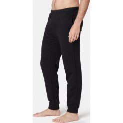 Spodnie dresowe Gym & Pilates 100 męskie. Czarne spodnie męskie NYAMBA, na co dzień, xl, bez wzorów, z elastanu. Za 39,99 zł.