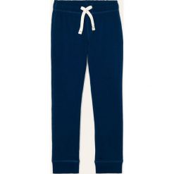 Blukids - Spodnie dziecięce 98-134 cm. Niebieskie spodnie chłopięce Blukids, bez wzorów, z bawełny, casualowe. Za 39,90 zł.