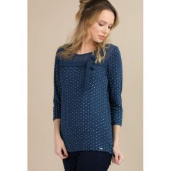 Elegancka bluzka w kropeczki. Bluzki damskie Monnari, bez wzorów, eleganckie, bez kołnierzyka, bez rękawów. Za 69,50 zł.
