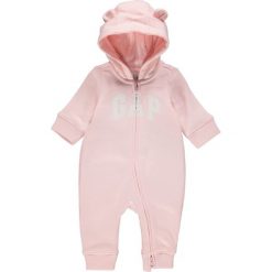 Pajacyk w kolorze jasnoróżowym. Różowe body niemowlęce Gap Kids, z aplikacjami, bez rękawów, bez kaptura. W wyprzedaży za 65,95 zł.