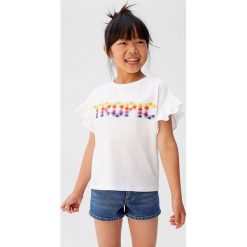 Mango Kids - Top dziecięcy Tropic 110-152 cm. Białe bluzki dziewczęce Mango Kids, z haftami, z bawełny, z okrągłym kołnierzem, z krótkim rękawem, krótkie, bez kaptura. W wyprzedaży za 29,90 zł.