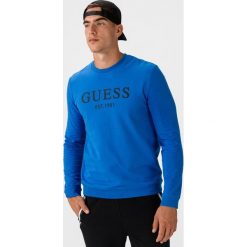 Guess Bastian Bluza Niebieski. Niebieskie bluzy męskie Guess, xl, z nadrukiem, z elastanu, bez kołnierzyka, bez rękawów, bez kaptura. Za 312,95 zł.