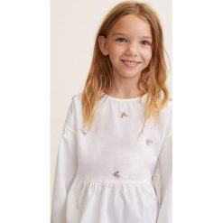 Mango Kids - Bluzka dziecięca Petra 110-164 cm. Białe bluzki dziewczęce marki Mango Kids, z aplikacjami, z bawełny, z okrągłym kołnierzem, bez rękawów, bez kaptura. W wyprzedaży za 59,90 zł.