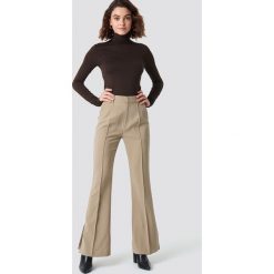 NA-KD Classic Spodnie garniturowe Seamline - Beige. Brązowe spodnie damskie NA-KD Classic, z poliesteru. Za 202,95 zł.