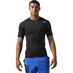KOSZULA WOR SL SS SLD COMP BLACK/BLACK. Czarne koszule męskie Reebok, m, z elastanu, z krótkim rękawem. Za 89,99 zł.