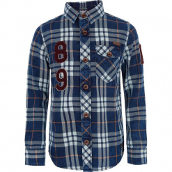 Koszula w kolorze niebieskim. Niebieskie koszule chłopięce marki Retour Denim de Luxe, z aplikacjami, z bawełny, z klasycznym kołnierzykiem. W wyprzedaży za 125,95 zł.