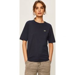 Lacoste - T-shirt. Czarne bluzki damskie Lacoste, bez wzorów, z bawełny, casualowe, z okrągłym kołnierzem. W wyprzedaży za 179,90 zł.