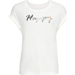 Shirt z cekinami bonprix biel wełny. Białe koszulki damskie bonprix, z napisami, z wełny, bez kołnierzyka, bez rękawów. Za 59,99 zł.