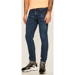 Diesel - Jeansy Thommer-X. Niebieskie jeansy męskie Diesel, z aplikacjami. W wyprzedaży za 399,90 zł.