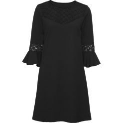Sukienka z dżerseju z koronką bonprix czarny. Czarne sukienki damskie bonprix, w koronkowe wzory, z koronki, bez kołnierzyka, bez rękawów. Za 59,99 zł.