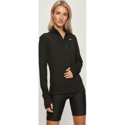 Reebok - Bluza. Czarne bluzy damskie Reebok, s, bez wzorów, z elastanu, z krótkim rękawem, krótkie, bez kaptura. Za 179,90 zł.