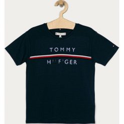 Tommy Hilfiger - T-shirt dziecięcy 104-176 cm. Białe bluzki dziewczęce TOMMY HILFIGER, z aplikacjami, z bawełny, z okrągłym kołnierzem, z krótkim rękawem, krótkie, bez kaptura. Za 139,90 zł.