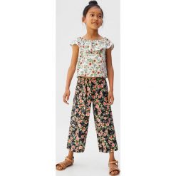 Mango Kids - Spodnie dziecięce Tropi 110-164 cm. Czarne spodnie dziewczęce Mango Kids, bez wzorów, z bawełny. W wyprzedaży za 59,90 zł.