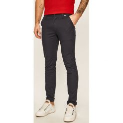 Calvin Klein - Spodnie. Niebieskie spodnie męskie Calvin Klein, bez wzorów, z elastanu. Za 549,90 zł.