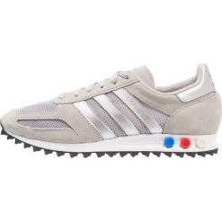 Adidas Originals LA TRAINER Tenisówki i Trampki solid grey/metallic silver/footwear white. Szare tenisówki damskie marki adidas Originals, z materiału. W wyprzedaży za 359,20 zł.