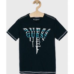 Guess Jeans - T-shirt dziecięcy 118-175 cm. Białe t-shirty chłopięce Guess Jeans, z nadrukiem, z bawełny, bez rękawów. W wyprzedaży za 49,90 zł.