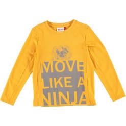 Koszulka "Tiger 116" w kolorze żółtym. Żółte t-shirty chłopięce LEGO Wear, z nadrukiem, z długim rękawem. W wyprzedaży za 49,95 zł.