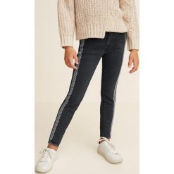 Mango Kids - Jeansy dziecięce Stand 110-164 cm. Czarne rurki dziewczęce marki Mango Kids, z aplikacjami, z bawełny. Za 99,90 zł.