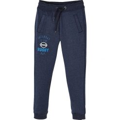 Spodnie dresowe w kolorze granatowym. Niebieskie spodnie niemowlęce Vertbaudet Boys & Co., z nadrukiem, z dresówki. W wyprzedaży za 35,95 zł.