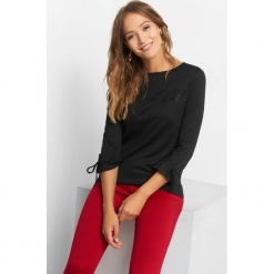 Koszulka z koronkową wstawką. Czarne t-shirty damskie Orsay, xs, w jednolite wzory, z dzianiny, z falbankami. Za 69,99 zł.