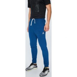 Reebok - Spodnie. Niebieskie spodnie męskie Reebok, m, z bawełny, sportowe. W wyprzedaży za 129,90 zł.