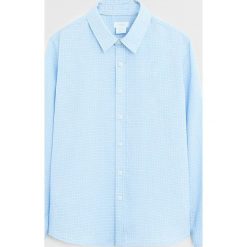 Mango Kids - Koszula dziecięca Cim 110-164 cm. Niebieskie koszule chłopięce Mango Kids, bez wzorów, z lyocellu, casualowe, bez kołnierzyka, z długim rękawem, długie. W wyprzedaży za 55,90 zł.