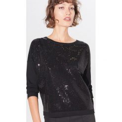 Bluza z cekinami - Czarny. Czarne bluzy damskie Mohito, s, bez wzorów, bez rękawów, bez kaptura. Za 99,99 zł.