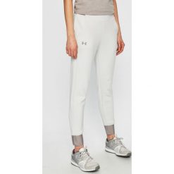 Under Armour - Spodnie. Białe spodnie sportowe damskie marki Under Armour, s, z poliesteru. Za 349,90 zł.