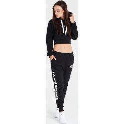 Naoko - Spodnie La Via Boheme Noir x Edyta Górniak. Czarne spodnie damskie marki NAOKO, s, z nadrukiem, z bawełny. W wyprzedaży za 129,90 zł.