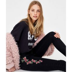 Jeansy rurki z krzyżykowym haftem. Czarne rurki damskie marki Pull & Bear. Za 69,90 zł.