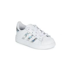 Buty Dziecko adidas SUPERSTAR EL I. Białe trampki dziewczęce Adidas, bez wzorów, bez zapięcia. Za 249,00 zł.