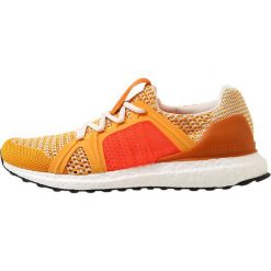 Adidas by Stella McCartney ULTRA BOOST Obuwie do biegania treningowe gold/rusora/turbo. Żółte buty damskie do biegania marki adidas by Stella McCartney, z tworzywa sztucznego. Za 899,00 zł.