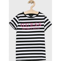 Guess Jeans - Top dziecięcy 118-175 cm. Różowe bluzki dziewczęce Guess Jeans, z nadrukiem, z bawełny, z okrągłym kołnierzem, z krótkim rękawem, krótkie, bez kaptura. W wyprzedaży za 79,90 zł.