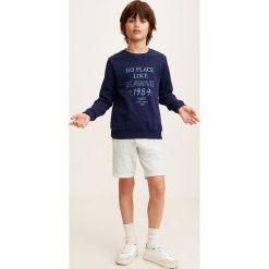 Mango Kids - Szorty dziecięce Indo 110-164 cm. Szare spodenki chłopięce Mango Kids, bez wzorów, z bawełny, casualowe. W wyprzedaży za 29,90 zł.