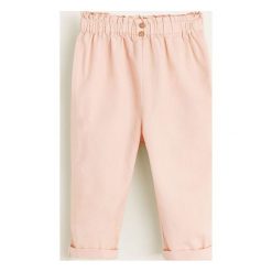 Mango Kids - Spodnie dziecięce Carla 80-104 cm. Różowe spodnie dziewczęce marki Mango Kids, bez wzorów, z bawełny, casualowe. Za 69,90 zł.