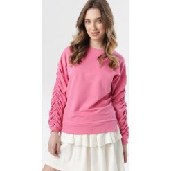 Różowa Bluza Phrigenia. Różowe bluzy damskie Born2be, xl, bez wzorów, bez rękawów, bez kaptura. W wyprzedaży za 54,99 zł.