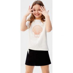 Mango Kids - T-shirt dziecięcy Shell 110-164 cm. Białe bluzki dziewczęce Mango Kids, z nadrukiem, z bawełny, z okrągłym kołnierzem, z krótkim rękawem, krótkie, bez kaptura. Za 59,90 zł.
