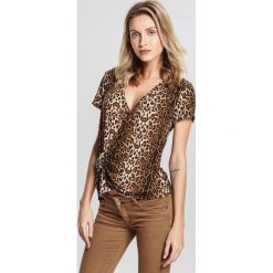 Brązowa Bluzka Panther. Pomarańczowe bluzki damskie marki other, s, bez wzorów, z dzianiny, bez kołnierzyka, z krótkim rękawem. Za 39,99 zł.