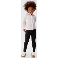 Mango Kids - Koszula dziecięca Yasmin 80-104 cm. Białe bluzki dziewczęce Mango Kids, bez wzorów, z bawełny, bez kołnierzyka, z długim rękawem, długie, bez kaptura. Za 69,90 zł.