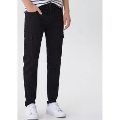 Spodnie slim fit z kieszeniami - Czarny. Czarne spodnie męskie House, s, bez wzorów. Za 139,99 zł.