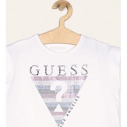 Guess Jeans - T-shirt dziecięcy 118-175 cm. Niebieskie bluzki dziewczęce Guess Jeans, z aplikacjami, z elastanu, z okrągłym kołnierzem, z krótkim rękawem, krótkie, bez kaptura. Za 99,90 zł.