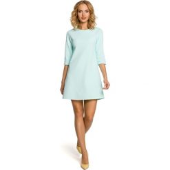 JENNA Trapezowa tunika - miętowa. Żółte tuniki damskie marki Moe, bez wzorów, z materiału, eleganckie, bez kołnierzyka, bez rękawów, trapezowe. Za 109,90 zł.