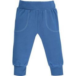Spodnie w kolorze niebieskim. Niebieskie spodnie niemowlęce lamino, bez wzorów, z bawełny. W wyprzedaży za 25,95 zł.