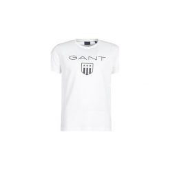 T-shirty z krótkim rękawem Gant PRINTED GANT SHIELD. Białe t-shirty męskie GANT, xl, bez wzorów, bez kołnierzyka, krótkie. Za 135,20 zł.