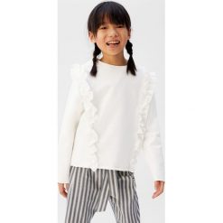 Mango Kids - Bluza dziecięca Sira 110-164 cm. Białe bluzy dziewczęce Mango Kids, bez wzorów, z bawełny, bez rękawów, bez kaptura. W wyprzedaży za 47,90 zł.