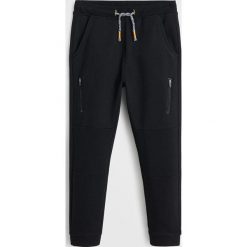 Mango Kids - Spodnie Lewis 110-164 cm. Czarne spodnie chłopięce Mango Kids, bez wzorów, z bawełny, casualowe. Za 69,90 zł.