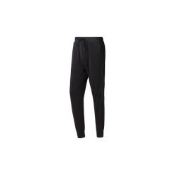 Spodnie Reebok Sport Spodnie dresowe Training Essentials Microfleece. Czarne spodnie męskie Reebok Sport, s, bez wzorów, z dresówki, sportowe. Za 229,00 zł.