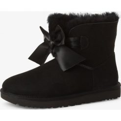 UGG - Skórzane kozaki damskie – Gita Bow Mini, czarny. Czarne kozaki damskie Ugg, z satyny, klasyczne, bez obcasa, bez zapięcia. Za 899,95 zł.