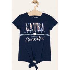 Guess Jeans - T-shirt dziecięcy 118-175 cm. Niebieskie bluzki dziewczęce Guess Jeans, z aplikacjami, z elastanu, z okrągłym kołnierzem, z krótkim rękawem, krótkie, bez kaptura. Za 99,90 zł.